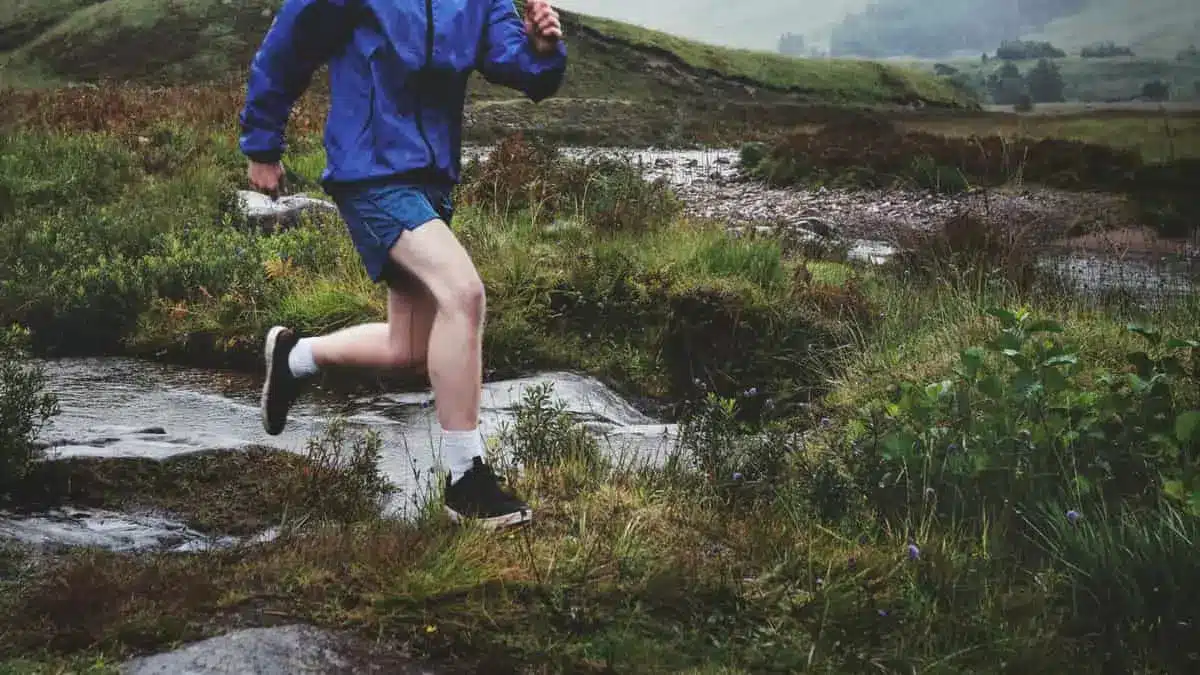 Are running shoes good for hiking. A man running on mountains wearing running shoes
