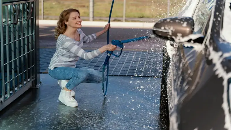 Are Vans Good for Wet Surfaces: girl cleaning a car