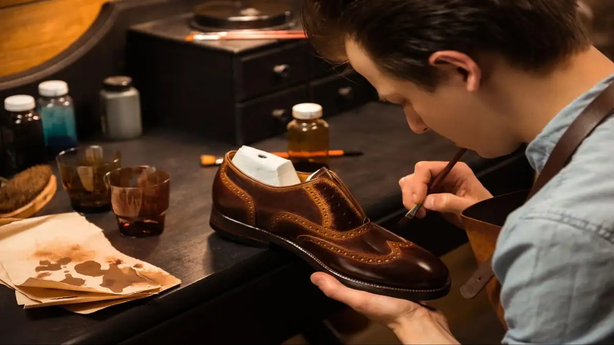 How to Make Your Boots Shine Like Glass. A man cleaning his shoes