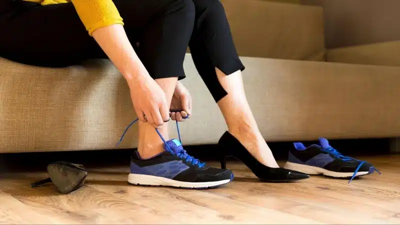 A Pair of Nike Wide Shoes Women's , a girl wearing her shoes
